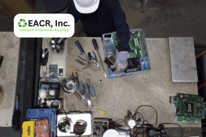 Worker dismantling a computer system