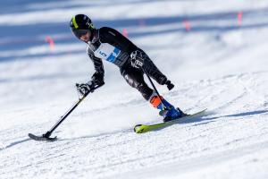 individual with leg amputation skiing down a mountain