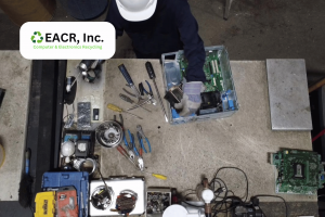 Worker dismantling a computer system
