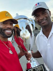 Don Wright celebrates his first-place finish at DJ Khaled’s ‘We The Best’ Golf Classic, proudly holding the championship trophy while representing Madison Insurance Group.