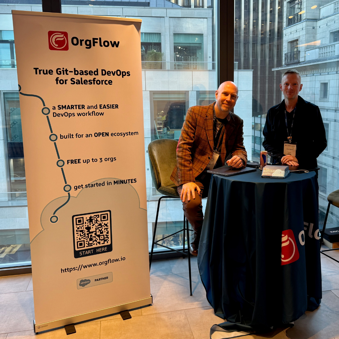 Two men represent OrgFlow at a professional event booth. Behind them, a large banner highlights the platform's benefits, including being 