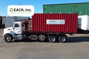 Red shipping container on roll off truck