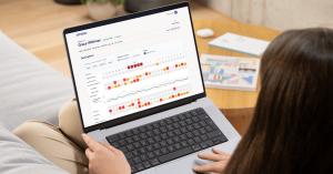 A laptop displaying Amissa’s clinical dashboard showing menopause symptom trends and wearable data organized for clinical review.