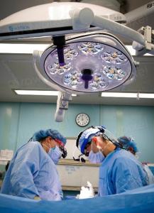 Surgeons prepare for a procedure in a hospital operating room, illustrating the clinical workforce central to neurosurgical care.