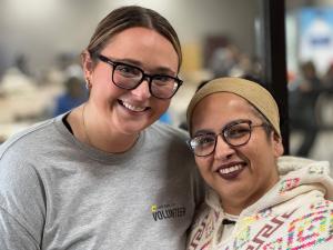 A volunteer poses with a client who received free tax help.
