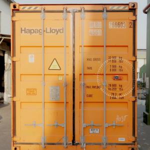 Yellow shipping container equipped with an IoT smart tracking device.