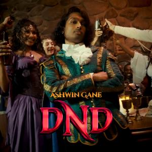 Ashwin Gane stands confidently in ornate teal and gold attire inside a crowded tavern‑style party scene, with the bold red DND title overlaid at the bottom.