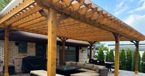 Large 6 Post Big Kahuna PLUS Cedar Covered Freestanding Custom Pergola with a roof providing protection from rain and sun in backyard dining and living room