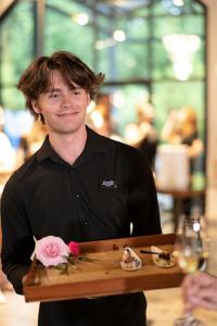 Vibrant Occasions Catering team member serves East Meets West Pork Belly during the FUSION360° culinary experience in Little Rock on August 28, 2025. Photo credit: Lori Sparkman Photography.