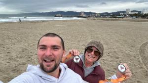 Chase DiMaggio Betta and Debbi DiMaggio celebrate at Santa Monica, CA, finish line after 10k High Tide Run.