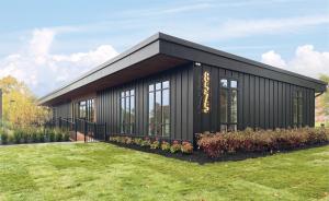 Birth Detroit birth center sitting below a blue sky with green grass.