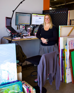 Betina Genovesi, strategist and curator of Clara Woods Collection and The Inclusion Matters Movement, standing in the studio workspace at Rogue Collective in Newport Beach, Calif.
