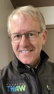 Headshot of Brian Cole wearing a Navajo THAW jacket, representing technology and workforce development initiatives.