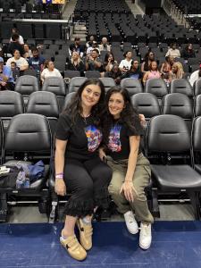 Farrah and Tamara Mechael seated courtside inside the Intuit Dome arena in Los Angeles.