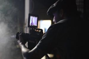 A photo of director Brad Alexander at work filming
