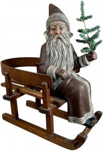 German terracotta Santa figure seated on wooden sleigh. Superb detail and realism of the strands of beard hair. Height: 22in. VG to Excellent condition overall with pristine Santa figure. Sold for $66,000