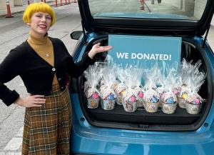 Annamarie von Firley standing next to open car trunk showing Easter baskets donated to Children's Hospital Los Angeles