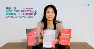 Mihae Ahn sitting behind three of her books about storytelling and leadership, reflecting her human-centered philosophy in technology.