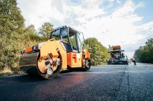 Road roller paving asphalt in Calgary