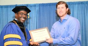 ASU President, Dr. Robert O. Scott Congratulates Student