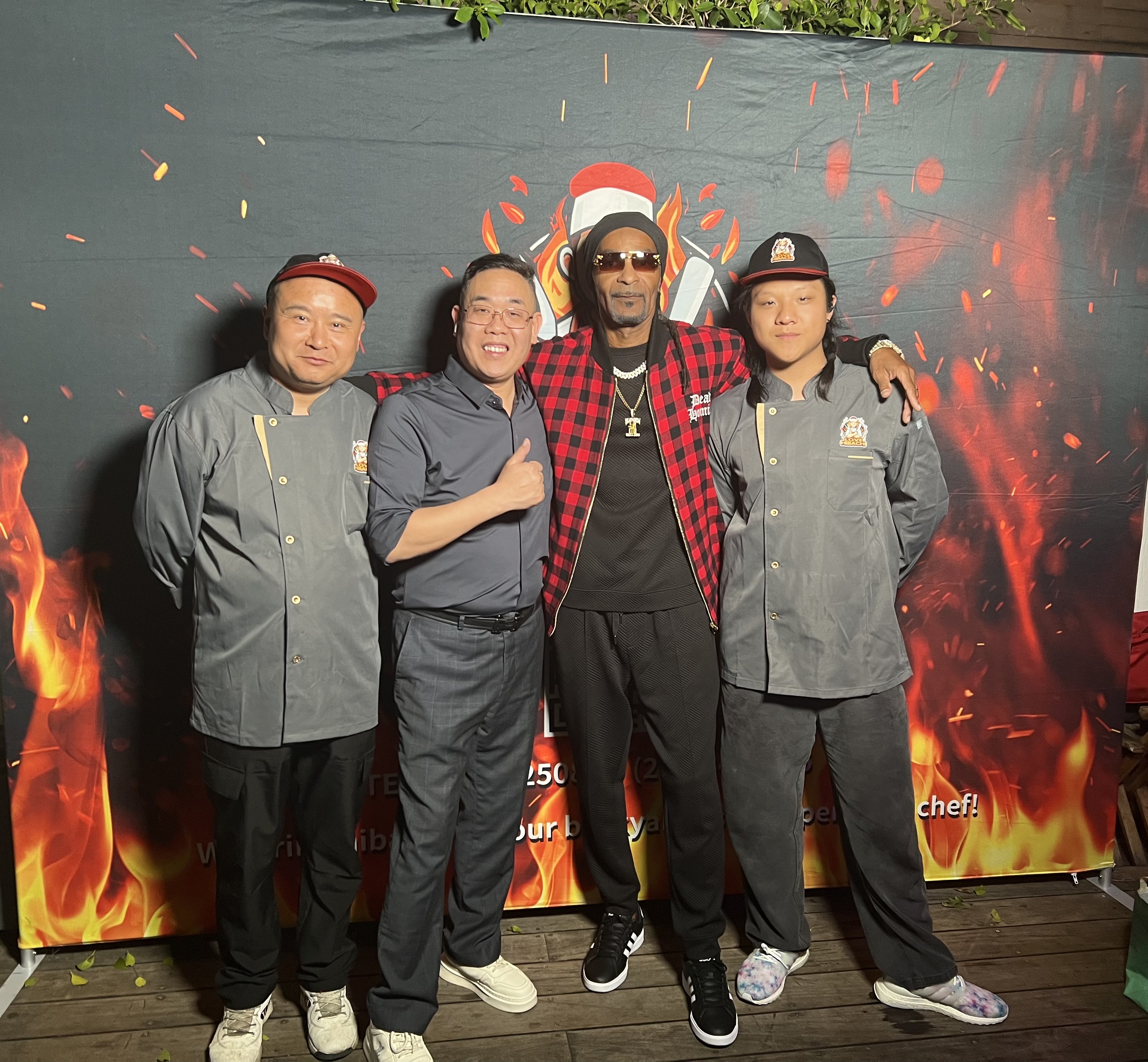 Love Hibachi CEO Mr. Li with a celebrity guest and the chef team at the March 12 event.