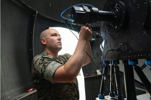 Naval Postgraduate School (NPS) graduate student U.S. Marine Corps Capt. Chris Henderson is using the NPS Mobile CubeSat Command and Control network and telescope to communicate with CubeSats using optical methods to transmit data.