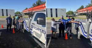 Detroit Vortex technicians celebrating SuperTech Day next to a Vortex door repair service truck with ladders