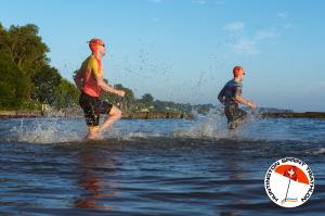 Two swimmers entering the water to swim