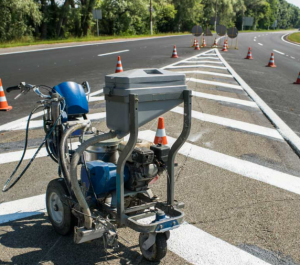 Professional asphalt line striping equipment used by Denny McCowan General Engineering Inc. for pavement marking and road safety projects.