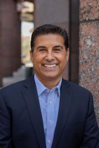 Headshot of Daryl Luna, CPA, Managing Partner of JLK Rosenberger LLP, smiling outside Irvine Office of JLK Rosenberger