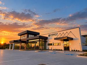 The state-of-the-art building that houses Texas Eye and Cataract and Everest Surgery Center is pictured in dramatic sunset lighting.