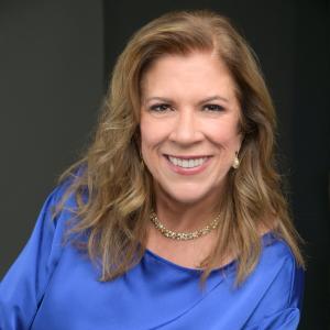 Jocelyn King, a cybersecurity advocate, is shown in her headshot smiling with arms folded.