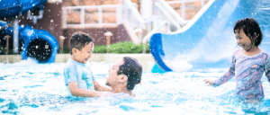 An Asian father with his son and daughter in a pool at Studio City Macau.
