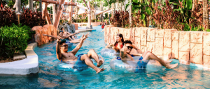 A group of young adults each on life buoy rings at a waterpark in Studio City Macau."