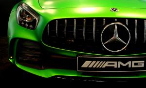 Close-up of vibrant green Mercedes-AMG sports car front featuring the iconic Panamericana vertical-slat grille, Mercedes star logo, LED headlight, and AMG badge on the license plate