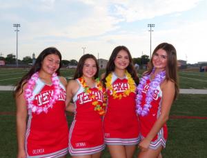 W.B. Ray High Fighting Texan All-American Cheerleaders to Perform in the Pearl Harbor Memorial Parade in Honolulu, HI 11 Image of four Ray High School cheerleaders wearing their red and white "Texans" uniforms. All four girls are also wearing Hawaiian inspired lei's around their necks.
