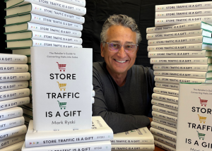 Author Mark Ryski is surrounded by copies of his latest book and Amazon Best Seller, Store Traffic is a Gift